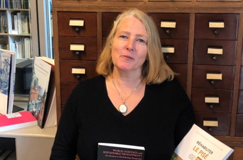 Daniela Sauer holding the three books highlighted in her review. Image courtesy of  ICCROM Library.